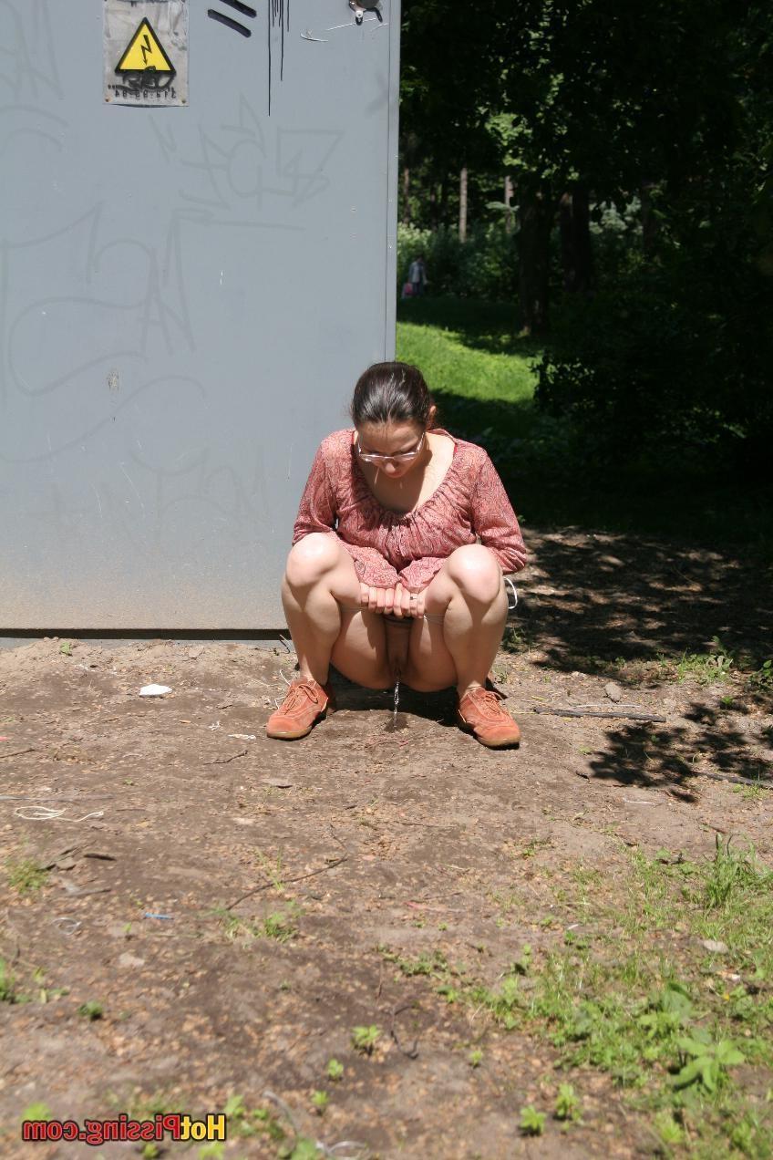 15P Cutie in glasses breaks her park walk and does a wee-wee cautiously
