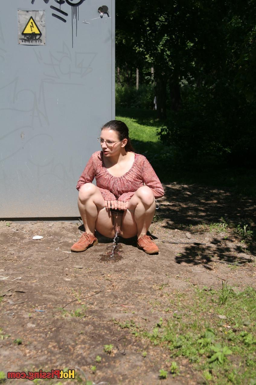 15P Cutie in glasses breaks her park walk and does a wee-wee cautiously