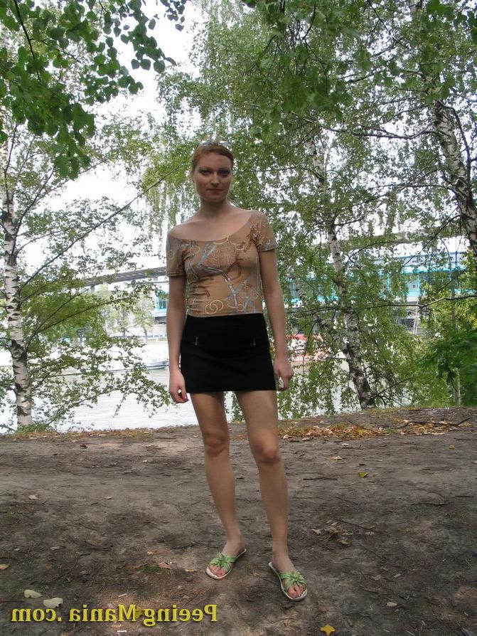 15P Longhaired beauty lifts up her skirt and squats to urinate riverside