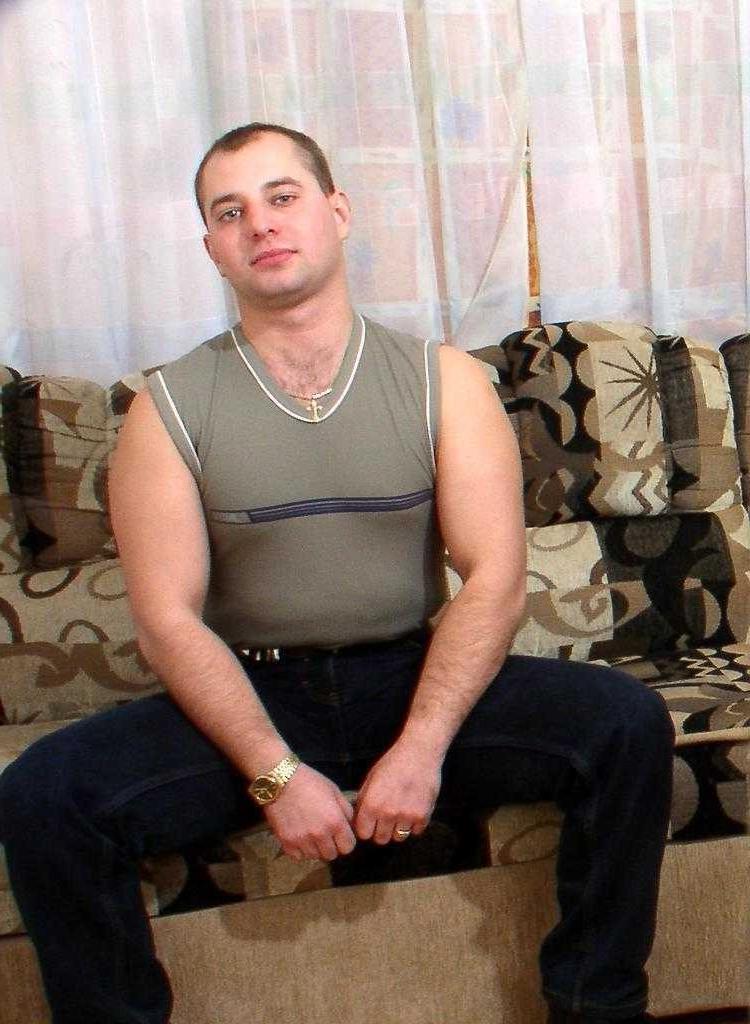20P Horny naked gay bear enjoys teasing and posing on a sofa