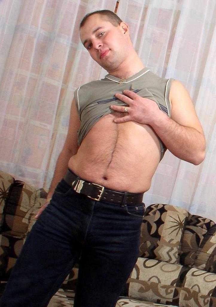 20P Horny naked gay bear enjoys teasing and posing on a sofa