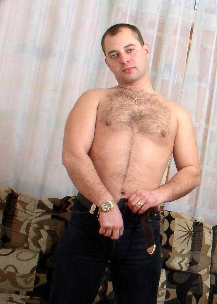 20P Horny naked gay bear enjoys teasing and posing on a sofa