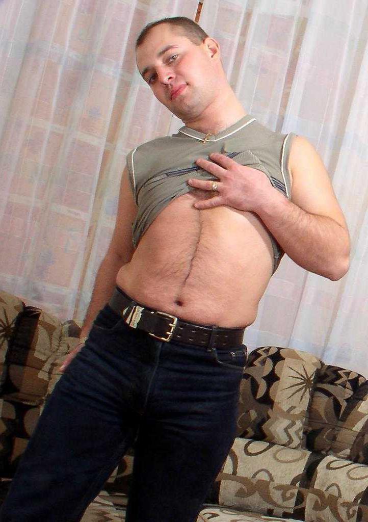 20P Horny gay bear loves to striptease and pose naked on couch