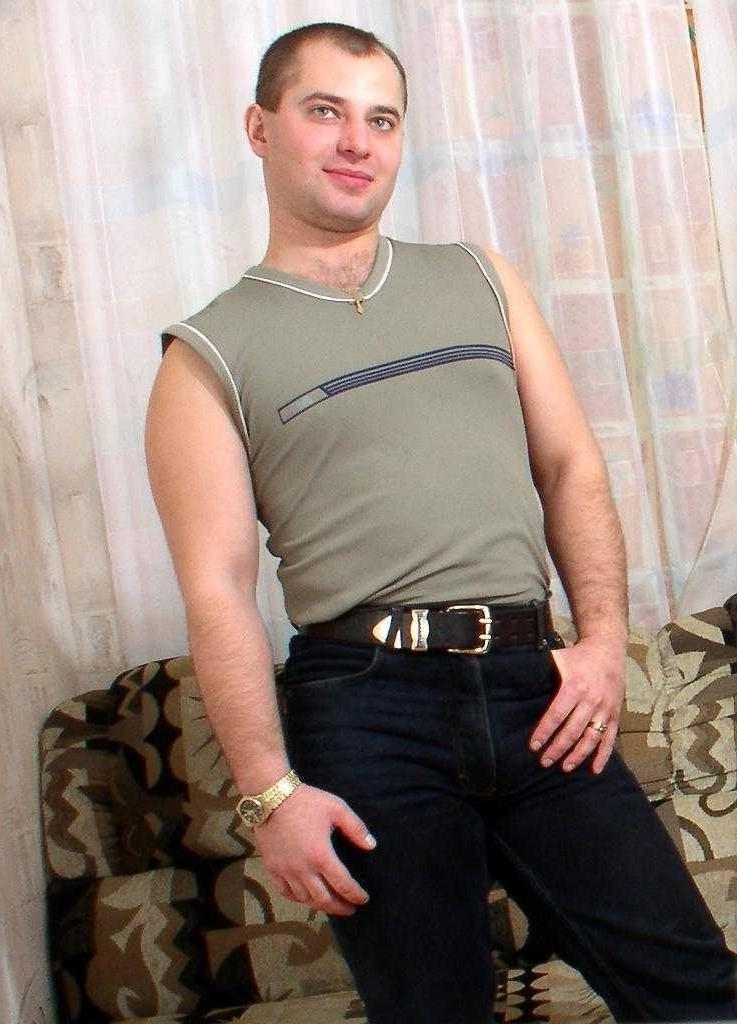 20P Horny gay bear loves to striptease and pose naked on couch