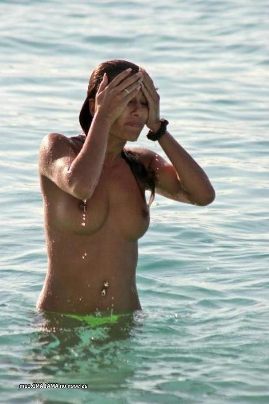 10P Compilation of a sexy Latina babe posing topless at a beach
