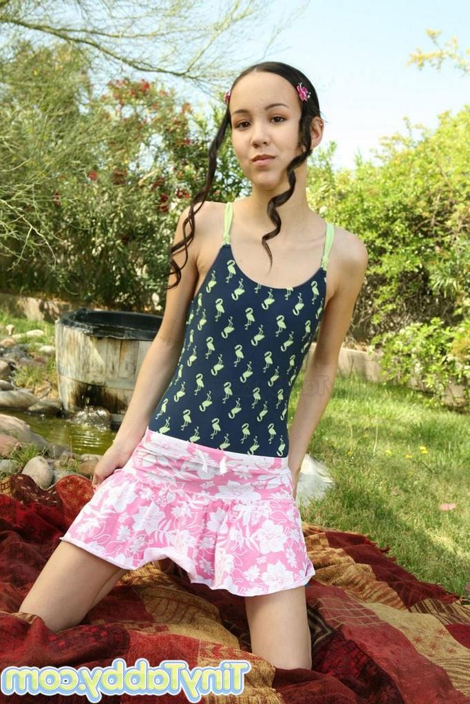 15P Small titted eighteen year old strips and spreads pussy outdoors