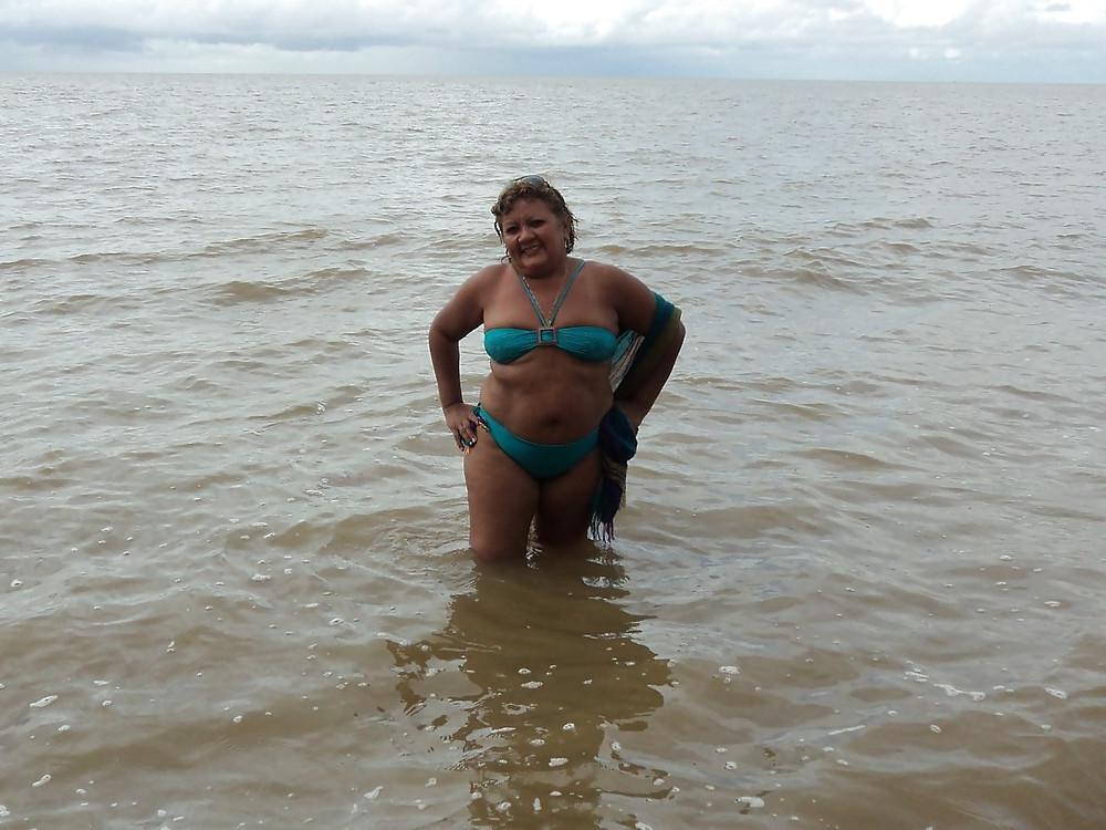 24P Women with saggy tits in swimsuit.