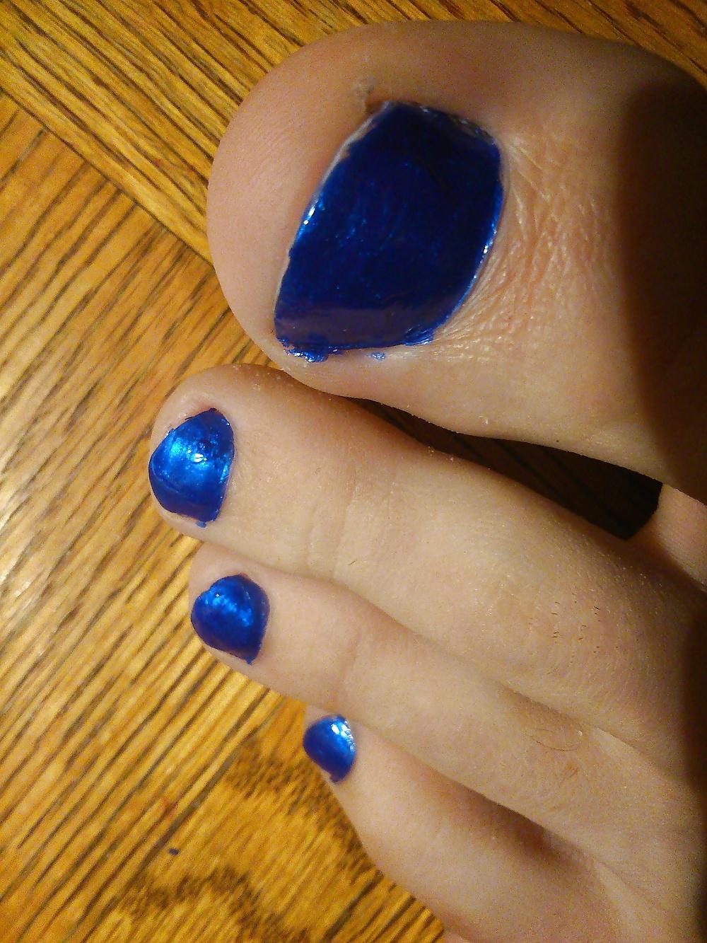 9P Feet And Toes In Blue Nail Polish And Leather High Heels.