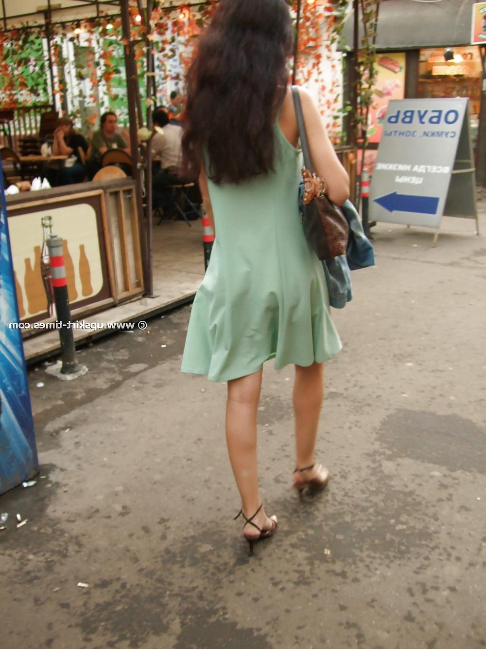 12P Brunette in high heels in a short light green summer dress