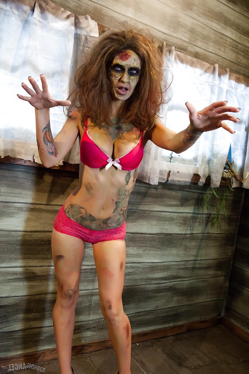 15P Saucy brunette cosplayer Kleio unveils her zombie tits and pussy