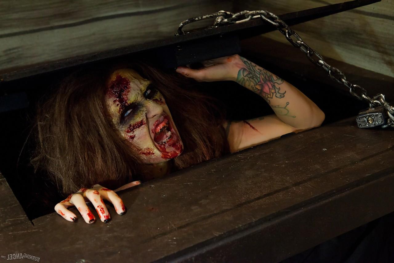 15P Saucy brunette cosplayer Kleio unveils her zombie tits and pussy
