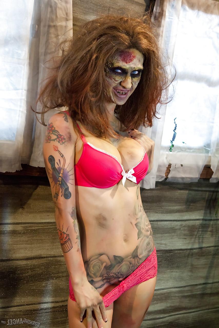 15P Saucy brunette cosplayer Kleio unveils her zombie tits and pussy