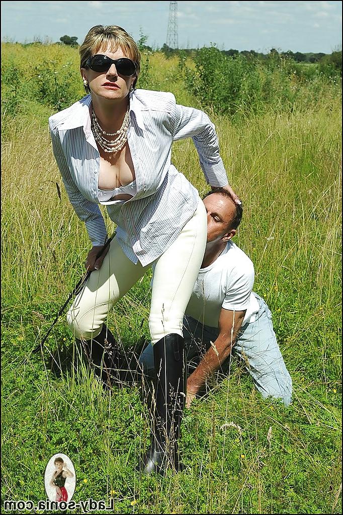 15P Busty mature femdom in sunglasses tortures her boyslave outdoor