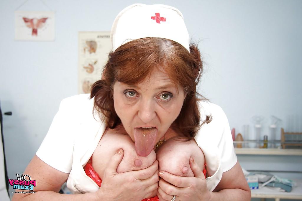 16P Redhead granny licking her flabby tits and playing with a big toy