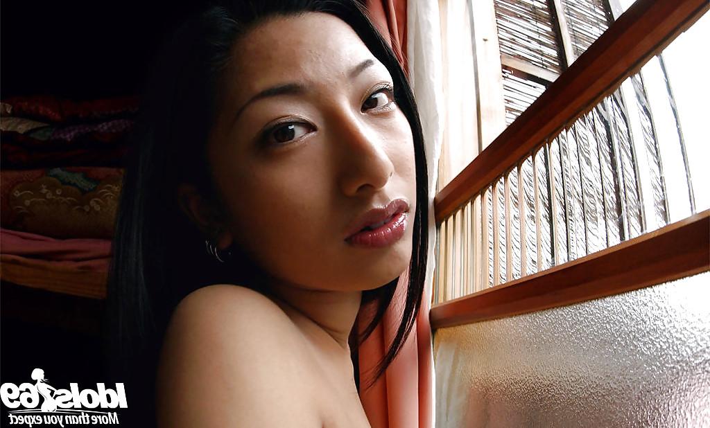 12P Graceful asian babe Ran Asakawa slipping off her lingerie