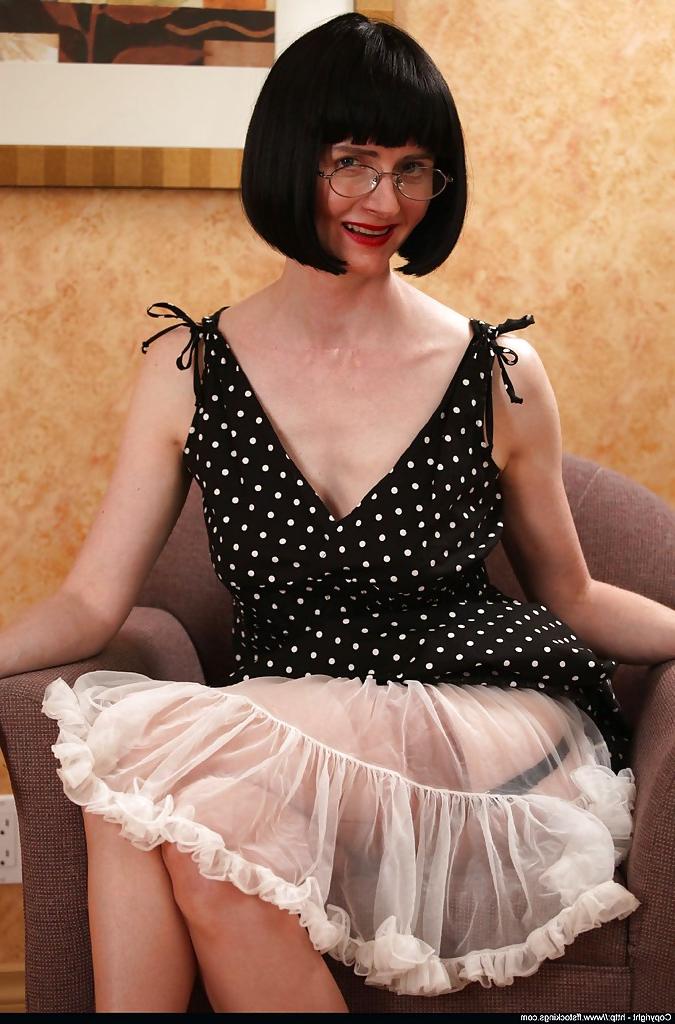 12P Sexy mature lady in stockings lifting her dress and underskirt up