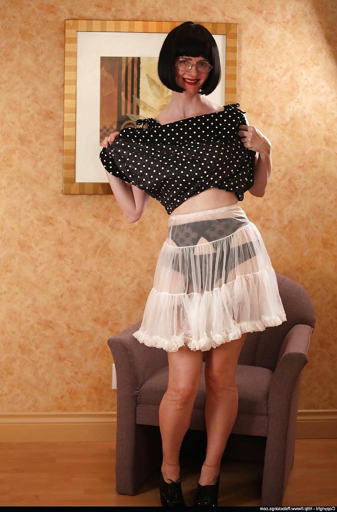 12P Sexy mature lady in stockings lifting her dress and underskirt up