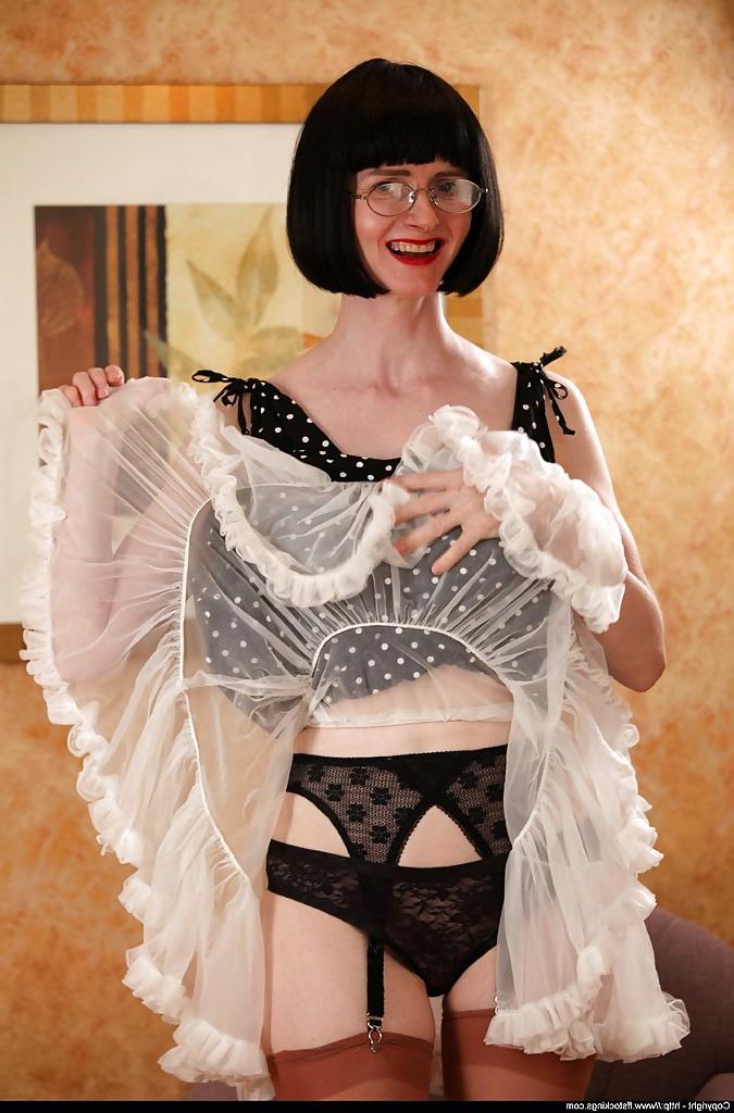 12P Sexy mature lady in stockings lifting her dress and underskirt up