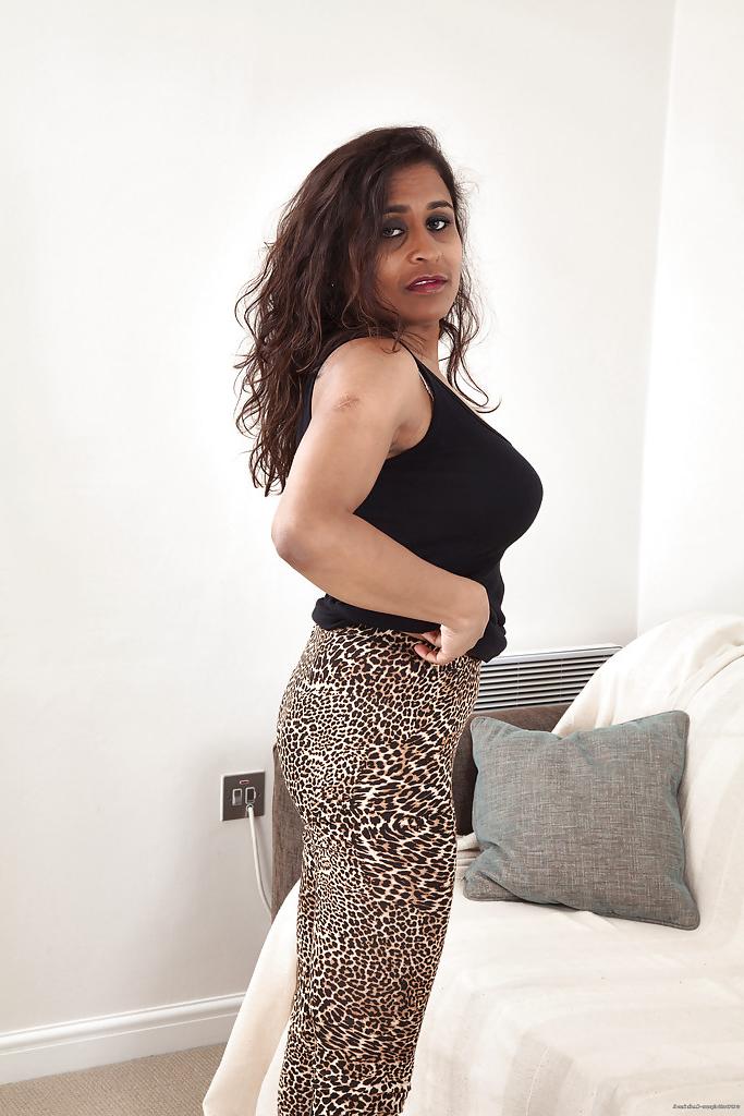 16P Dirty-minded mature gal with hairy twat undressing and spreading her legs