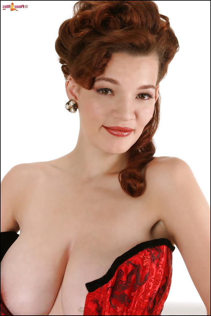 16P Busty beauty in tight corset is willing to show her comely tits