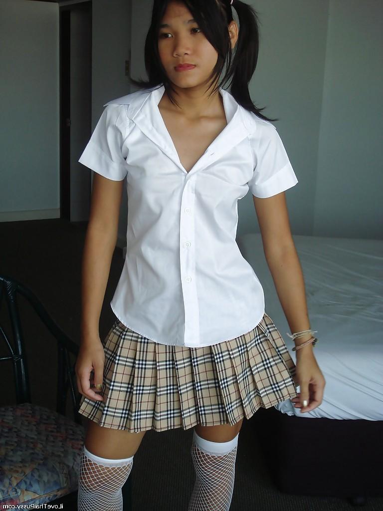 16P Asian cutie in mini skirt and stockings stripping and playing with a dildo