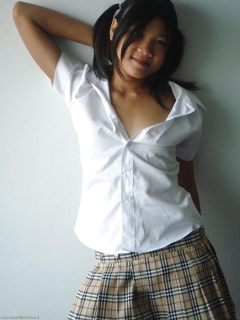 16P Asian cutie in mini skirt and stockings stripping and playing with a dildo