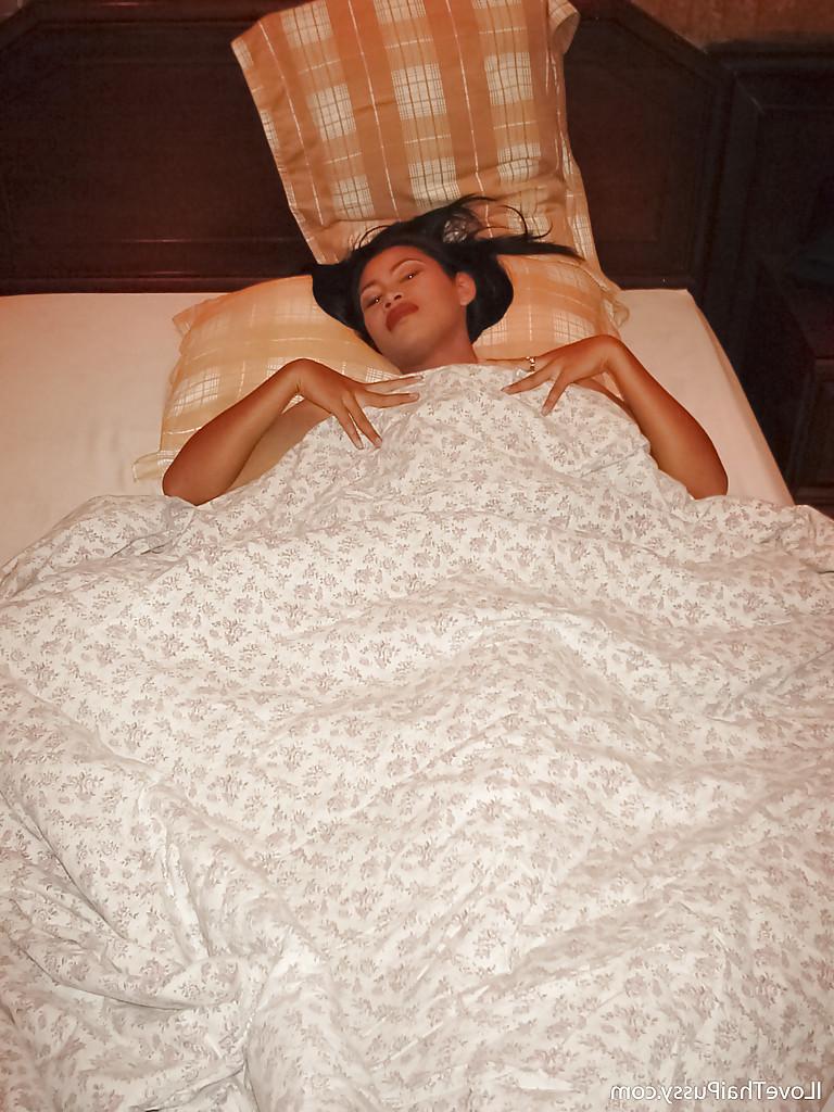 16P Busty asian babe slipping off her clothes and posing naked on the bed
