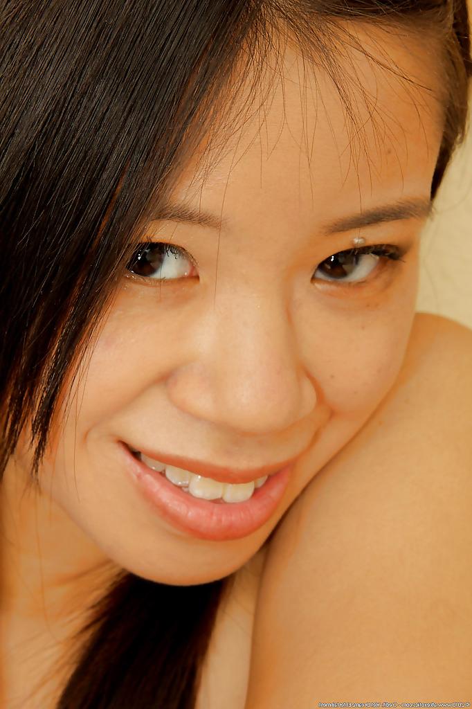 16P Exotic cutie Asia Zo lifts skirt for nice upskirt of white panties