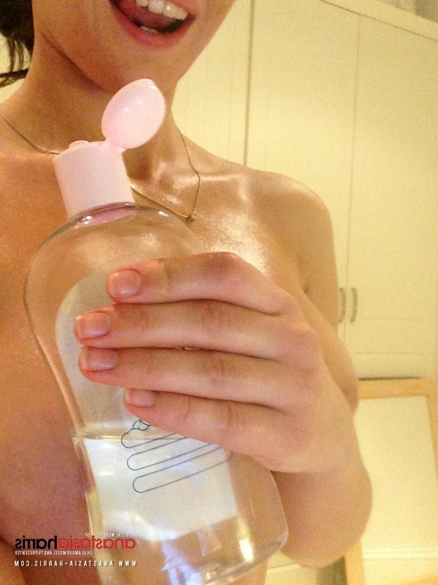 12P Anastasia Harris rubs some oil on her sexy boobies
