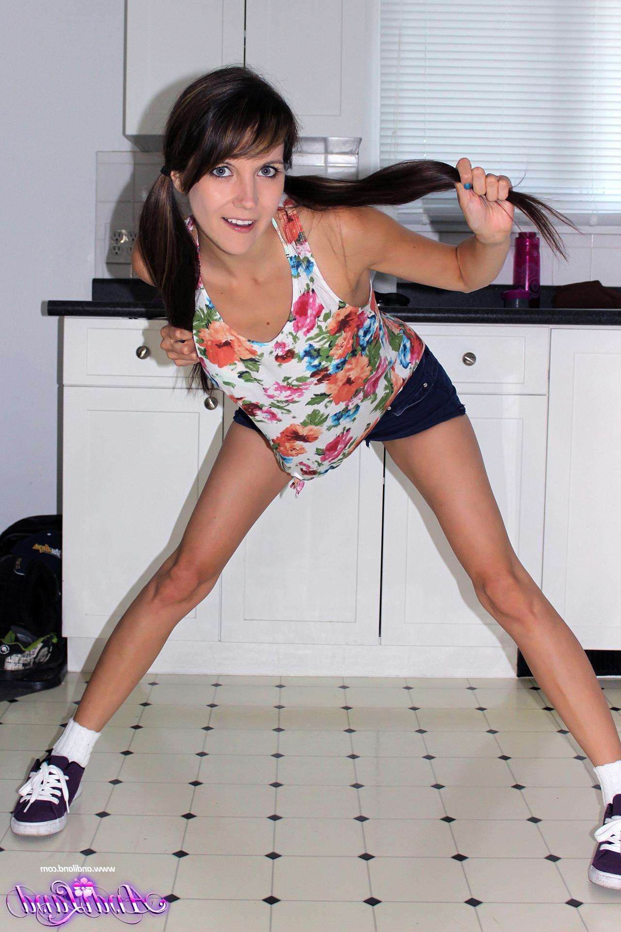 15P Andi Land strips and plays with her dildo in the kitchen