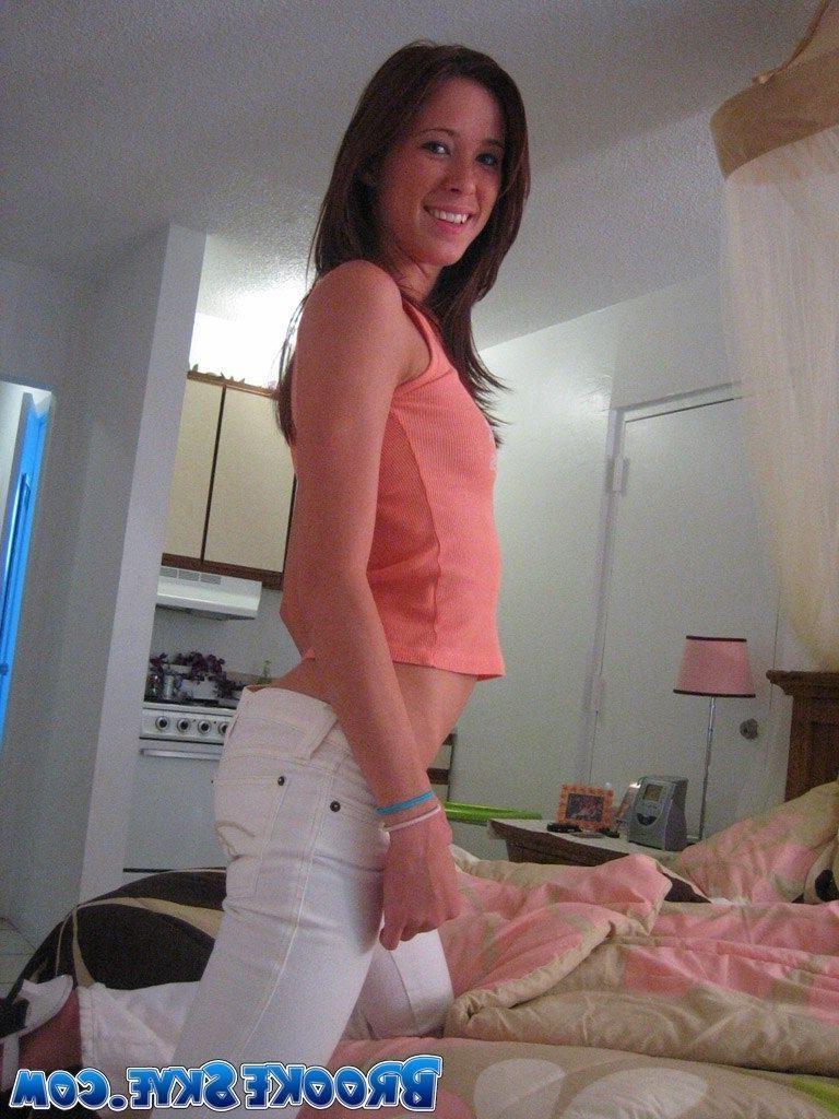 15P Brooke playing on the bed in white pants