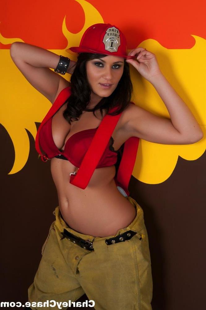 15P Pornstar Charley Chase strips out of a Fire Fighter suit to show off her big tits.
