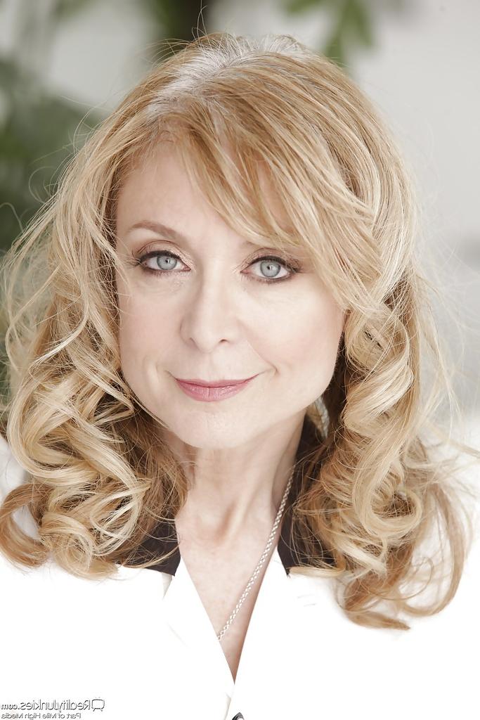 16P Mature vixen Nina Hartley gets rid of her dress clothes and lacy lingerie
