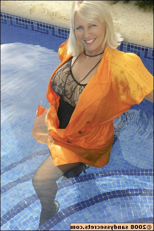 12P Elegant mature Sandy Spain modeling in see-thru lingerie and stockings at the pool
