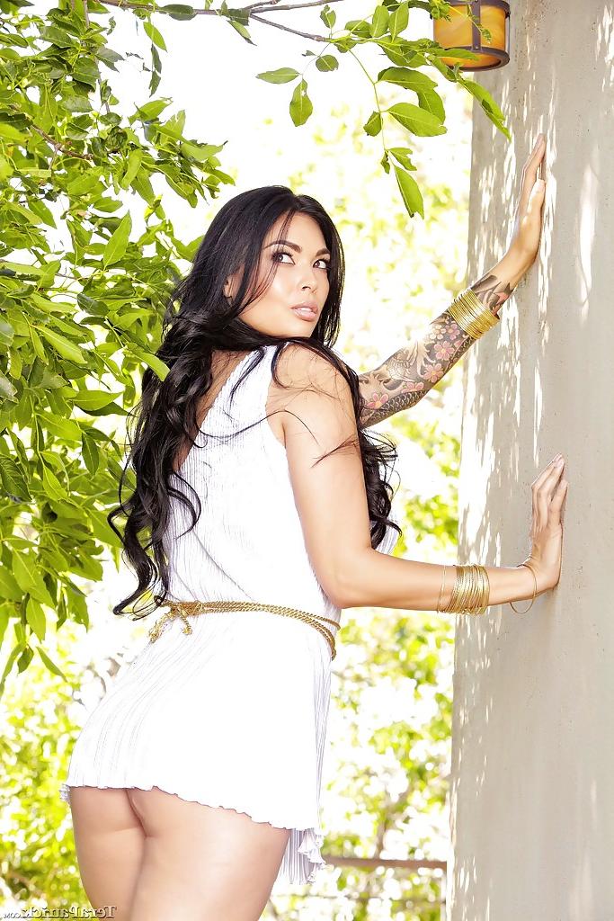 16P Ravishing tattooed pornstar revealing her big tits and shaved gash outdoor