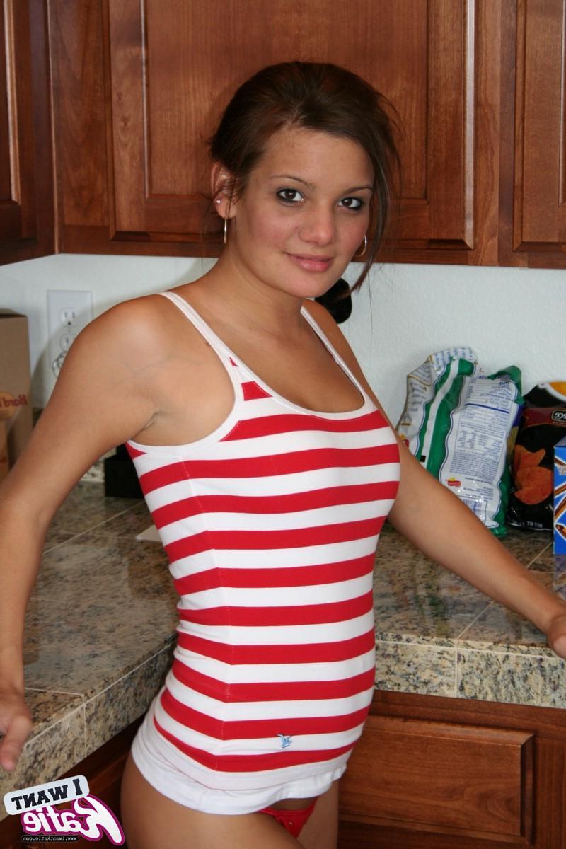 12P Busty teen Katie loves to get naked as she strips in the kitchen