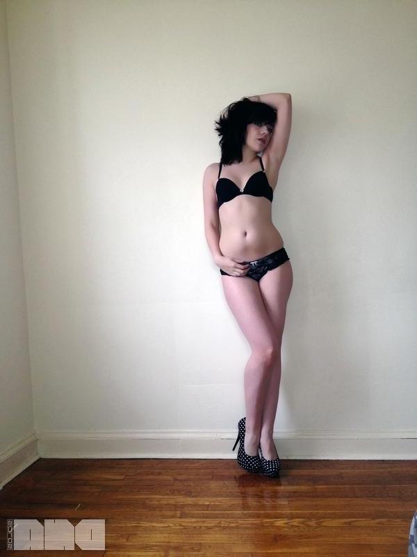 15P Sexy pinup Lilly Rose poses her hot body by the wall