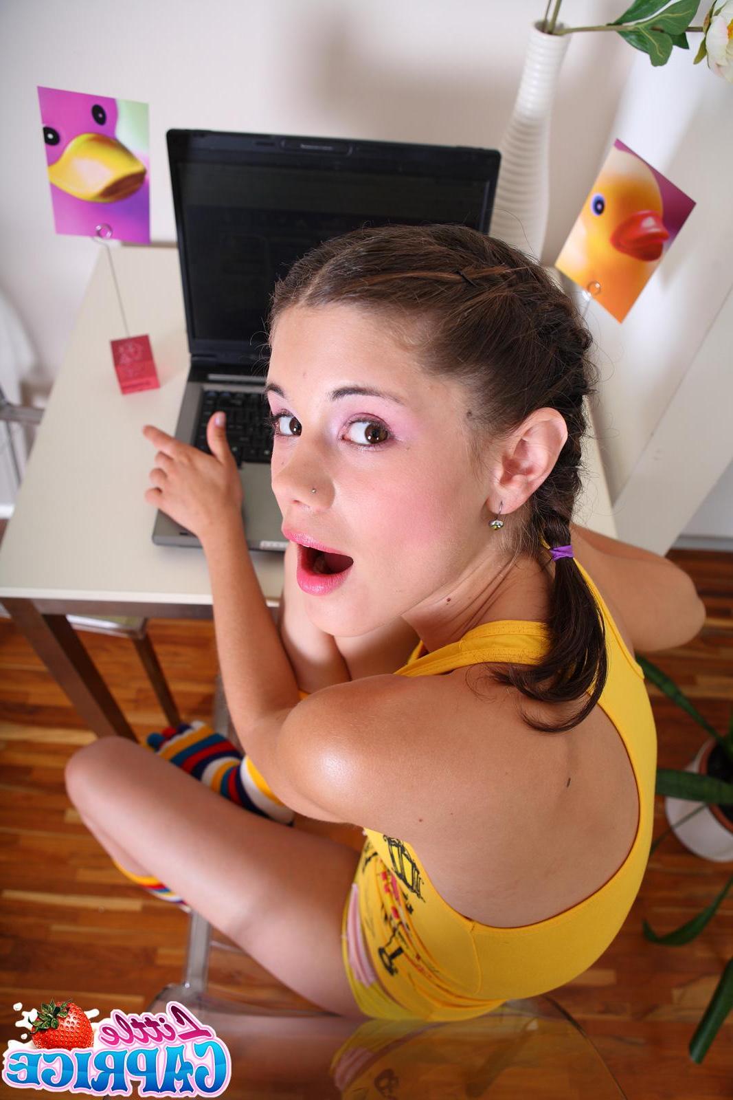 20P Pictures of Little Caprice getting naked at her computer