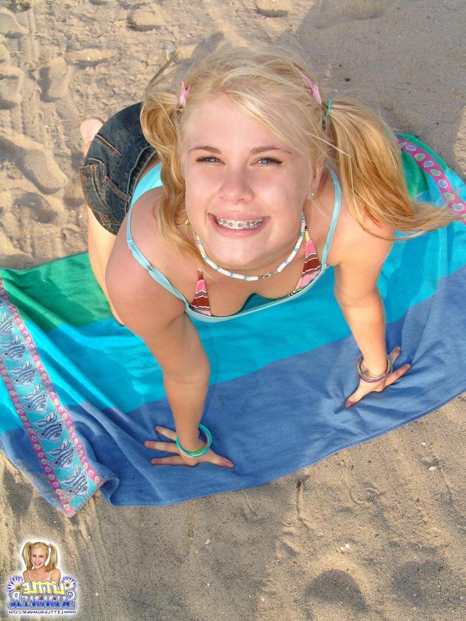 12P Pictures of hot blonde teen Little Summer having some fun on the beach