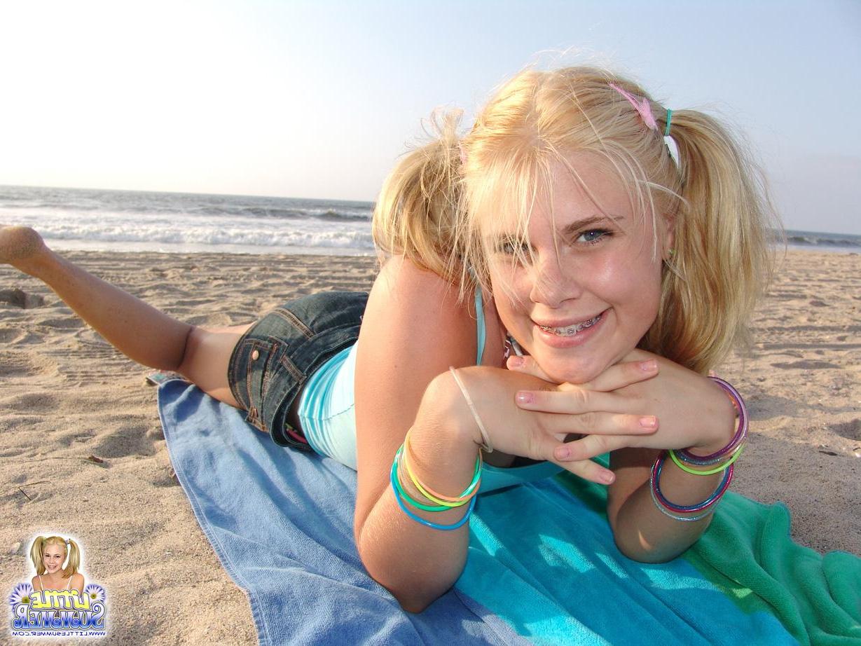 12P Pictures of hot blonde teen Little Summer having some fun on the beach