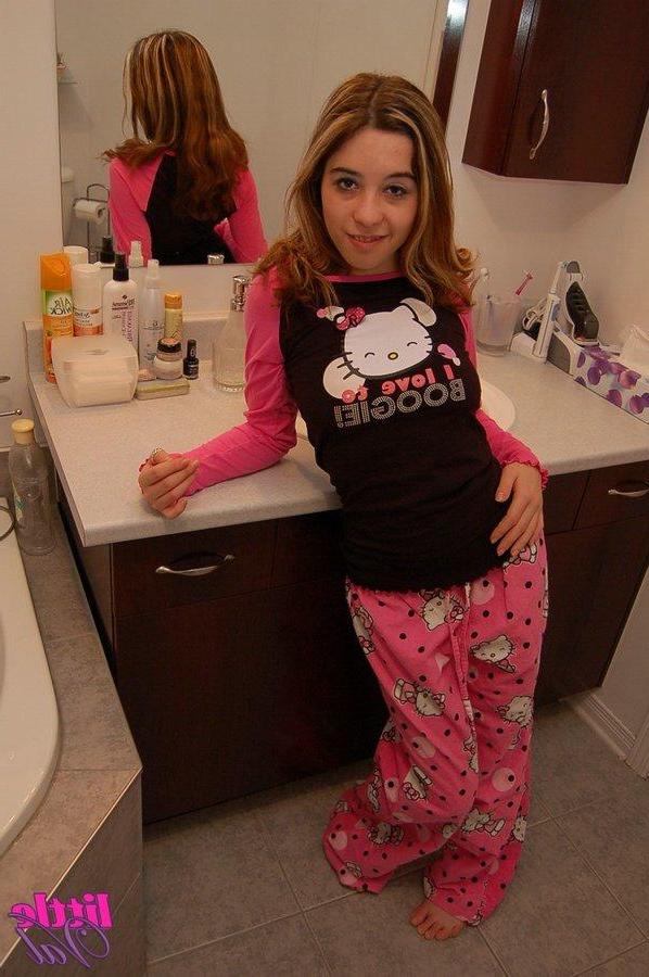 15P Pictures of teen model Little Val taking off her pajamas