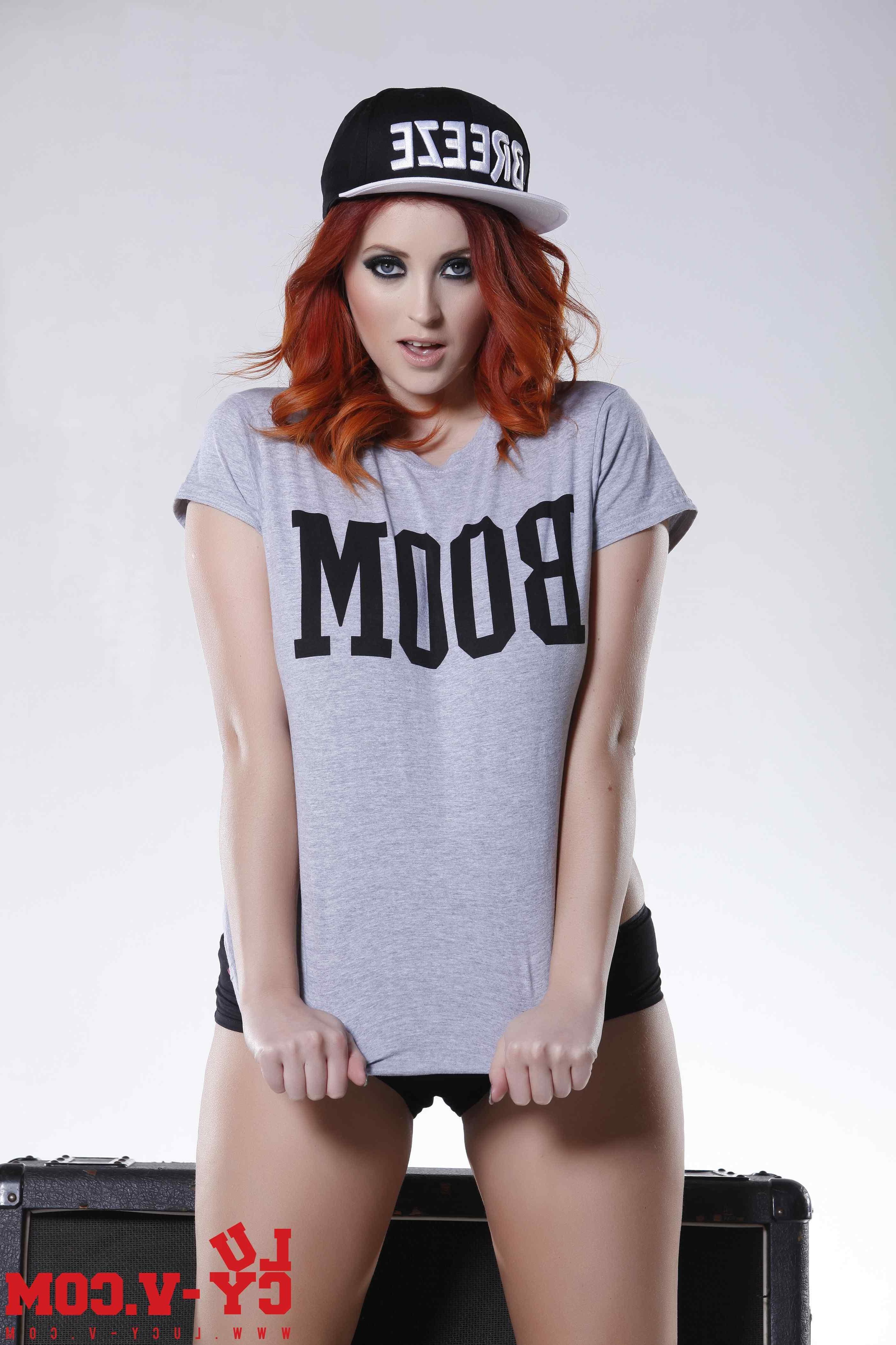 12P Hot redhead Lucy V looks sexy as she strips out of her tight gray shirt