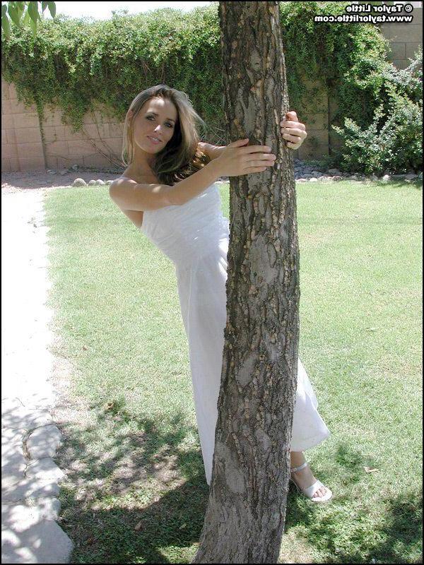 20P Pictures of teen hottie Taylor Little stripping by a tree