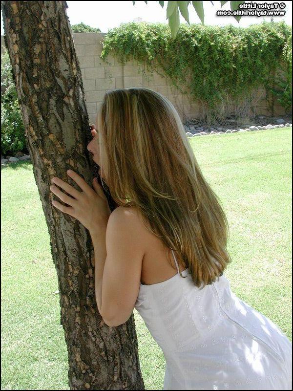 20P Pictures of teen hottie Taylor Little stripping by a tree
