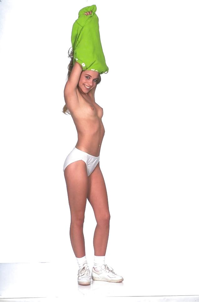 25P Brunette teenie in green dress stripping