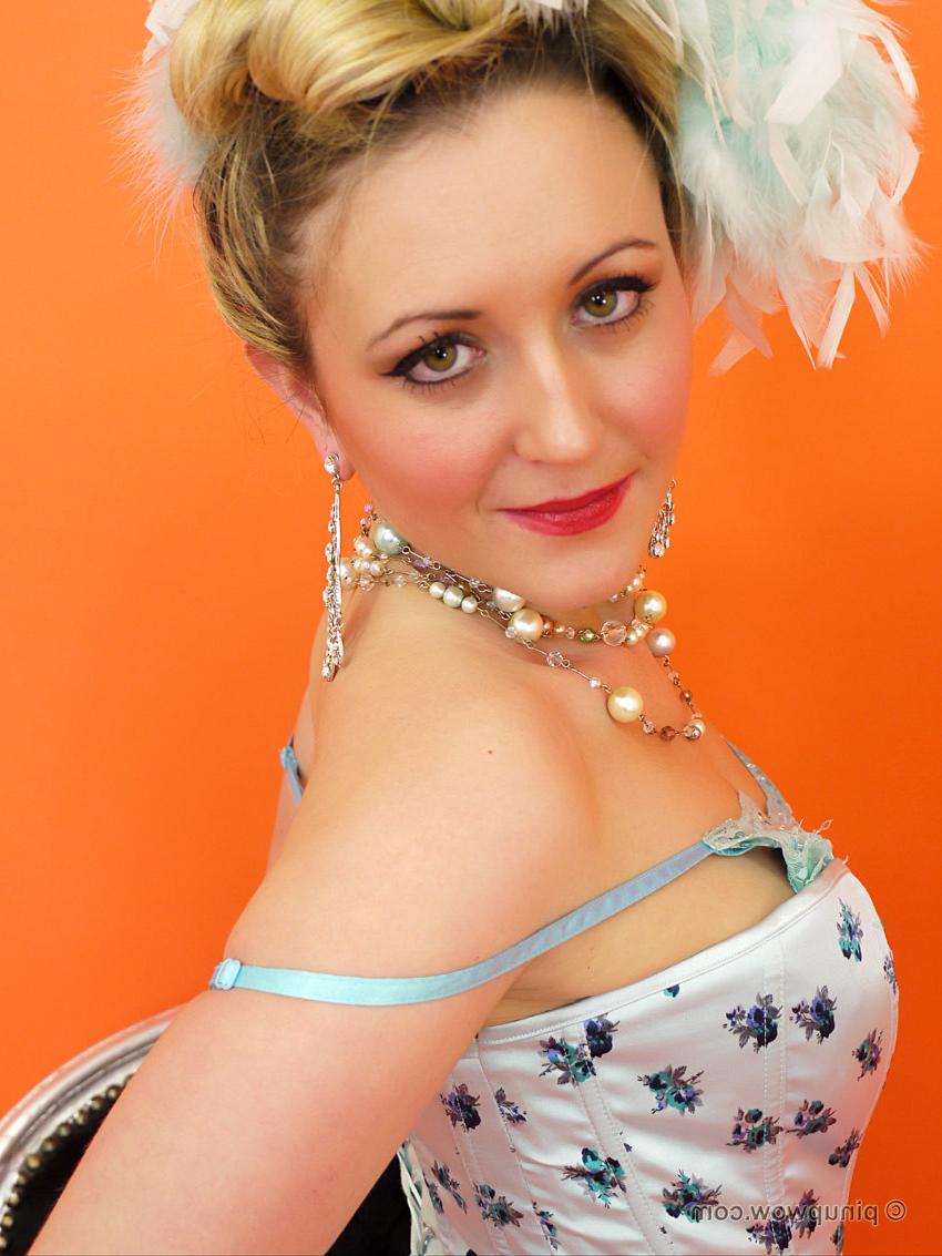 17P Saucy blonde showgirl in corset and white fishnet stockings know