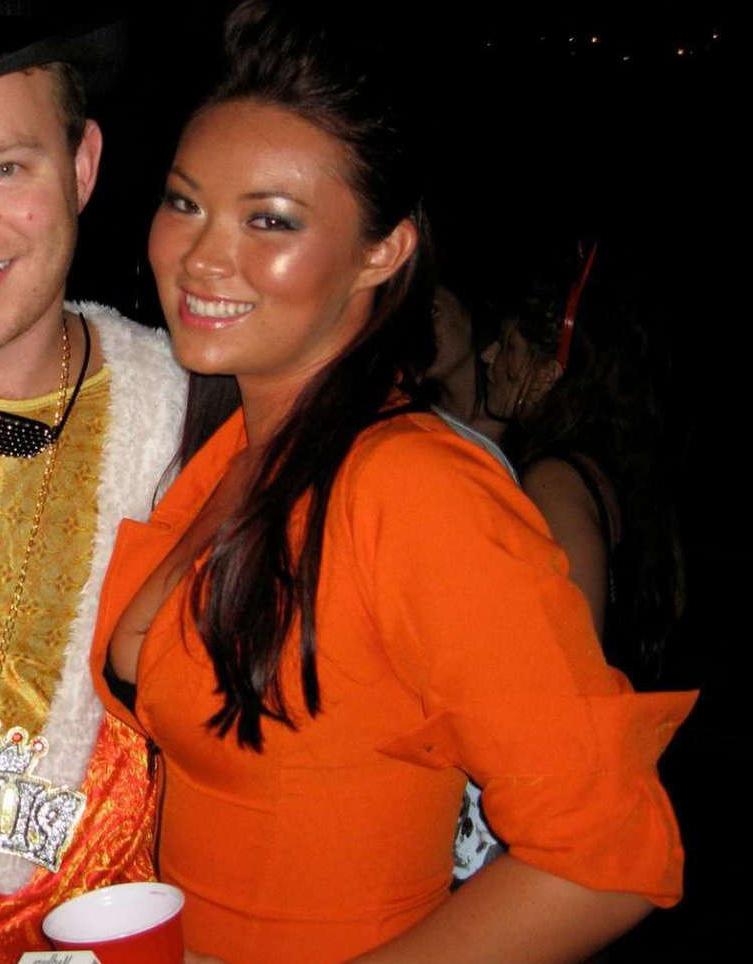 15P Pictures of an Oriental tease posing sexy in a party