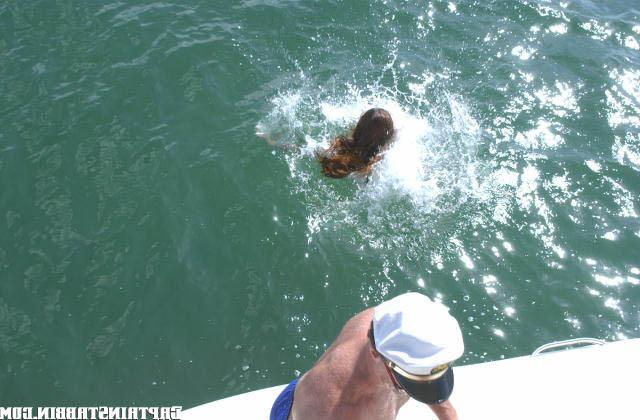12P Cute little brunette swims back to the shore after a hard bang on boat