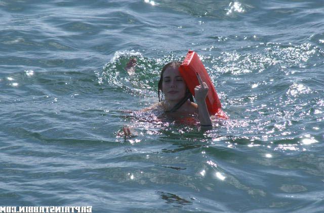 12P Cute little brunette swims back to the shore after a hard bang on boat