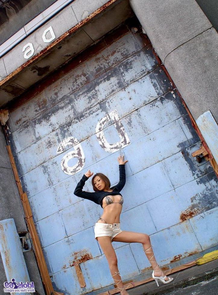 15P Cute japanese babe June poses in corset shows tits